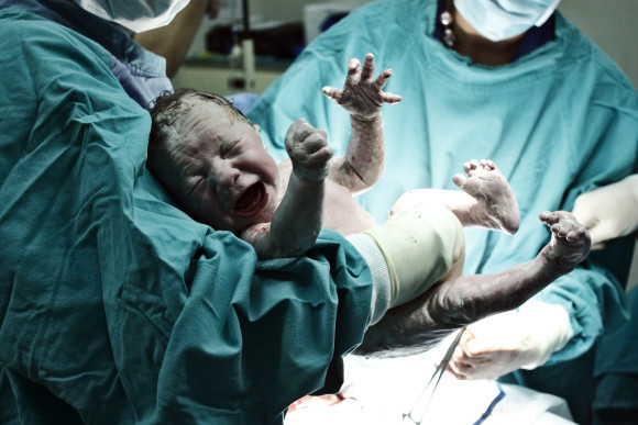 Doctor holding new born
